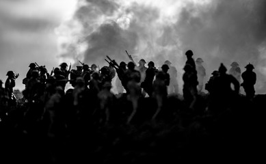 Fototapeta na wymiar War Concept. Military silhouettes fighting scene on war fog sky background, World War Soldiers Silhouettes Below Cloudy Skyline At night. Attack scene. Armored vehicles. Tanks battle. Decoration