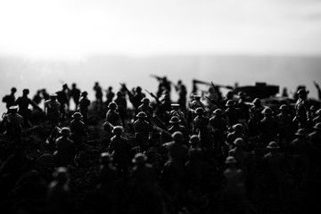 War Concept. Military silhouettes fighting scene on war fog sky background, World War Soldiers Silhouettes Below Cloudy Skyline at sunset. Attack scene. Armored vehicles.