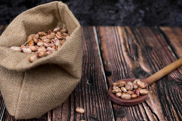 Organic Colorful Beans on Dark Wooden Background