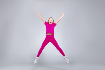 Young caucasian girl doing gym exercises in sportwear