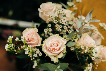 Pink Roses bouquet in a vase on a wooden table. Florist