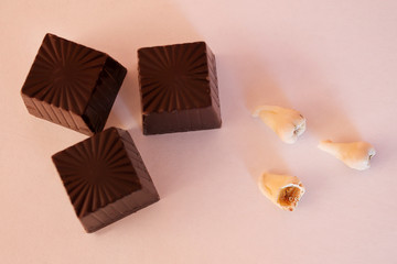 Teeth with large defects are located next to chocolates. The concept of prevention of dental disease.