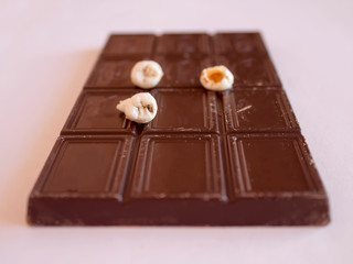 Teeth with large defects lie on chocolates. The concept of prevention of dental disease.