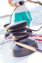 Sailboat winch with rope on yacht deck