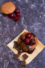 Muffin, chocolate, cherry, rustic style background concept