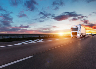 Loaded European truck on motorway in sunset