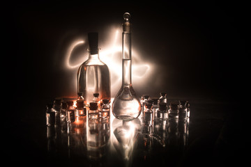 Obraz na płótnie Canvas Pharmacy and chemistry theme. Test glass flask with solution in research laboratory. Science and medical background. Laboratory test tubes on dark toned background