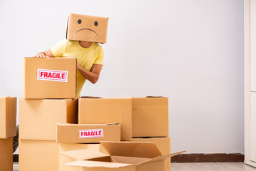 Unhappy man with box instead of his head 