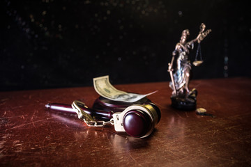 Law scales, dollars cash money, judge gavel, handcuff. Vintage old style sepia photo with fog