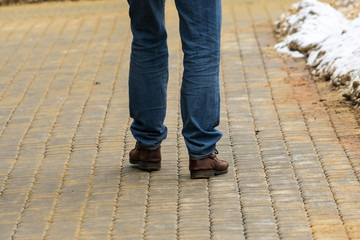 Man walking on the tiled sidewalk in winter.
