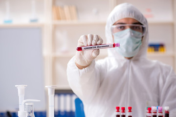 Young handsome chemist working in the lab 