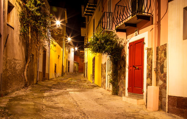 Narrow ancient streets during the evening in the little medieval town Bosa, Sardinia Island, Italy