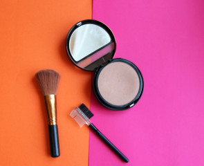 Obraz na płótnie Canvas background cosmetics powder brush blue pink orange
