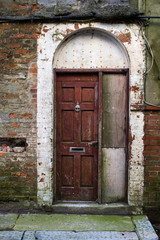 Arched doorway that looks shabby and in need of attention