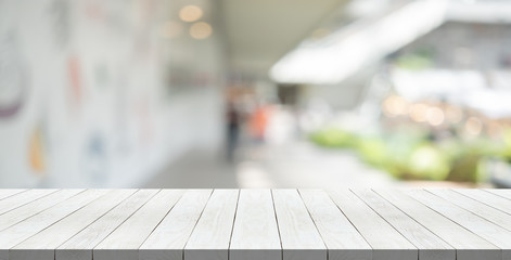 Wood table top on blurred background from shopping mall, Space for montage your products