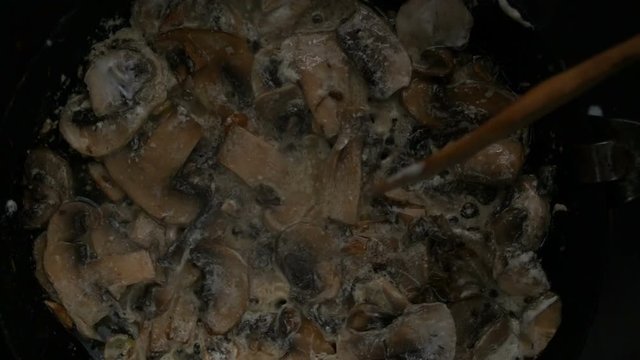 roasting garlic and champignon mushrooms on an old cast-iron pan
