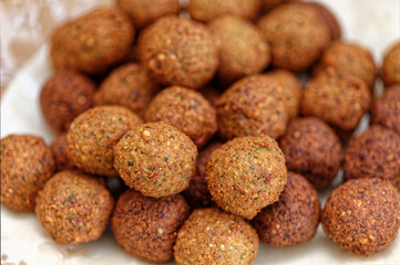 Deep frying falafel. Traditional Mediterranean healthy and vegan food with chickpeas and tahini. Selective focus, shallow depth of field