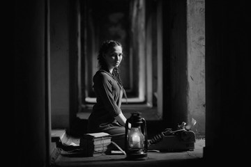 Retro girl in the old house reading books