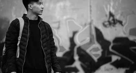 Black White photo of Asian young man outdoors posing