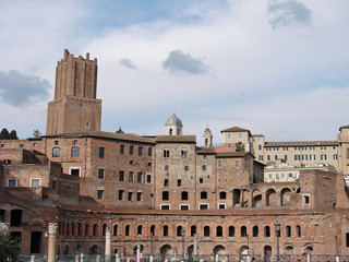 Fototapeta na wymiar Forum of Cesari in Rome with Trajan's Column and church in background