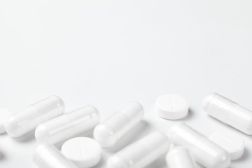 White tablets on white background with copy space.