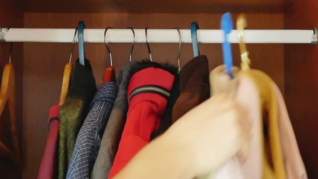 getting new job concept. removing all casual clothing from wardrobe and putting formal suit on hanger