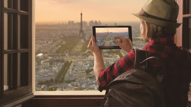 tourist takes photo of eiffel tower,traveler woman photographs paris city skyline using tablet high view
