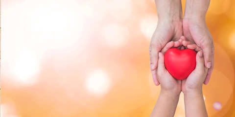 I love you Mom, Mother's Day celebration with woman parent holds young kid's hands supporting red heart gift, csr charity donation, parenting or children adoption family health nursing care concept