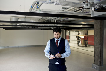 Property surveyor assessing new build commercial office space