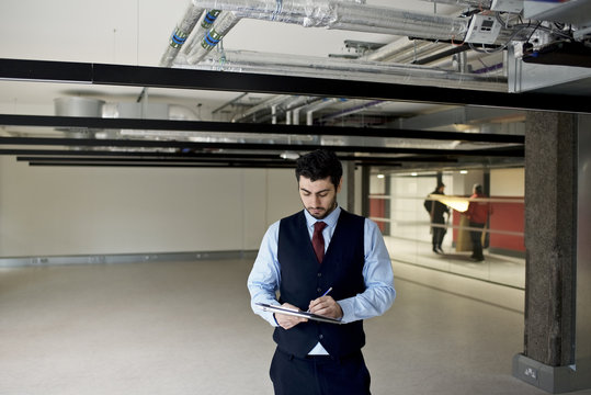 Property surveyor assessing new build commercial office space
