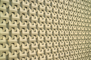 3D pattern of a modern building's outer wall in the warm sunlight