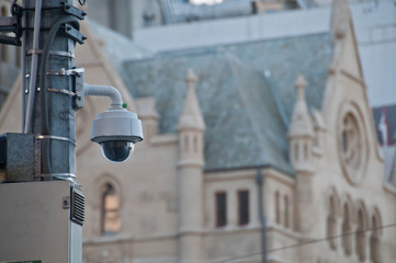 Surveillance CCTV street outdoor camera watching pedestrian near