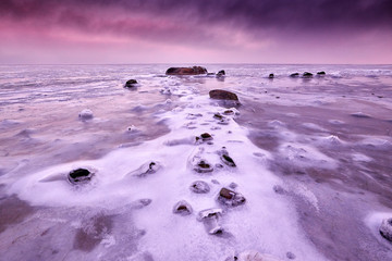 view on rock in icy baltic sea