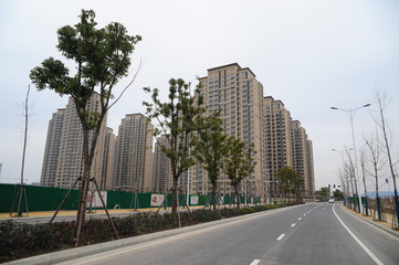 A group of tall buildings on the side of the road