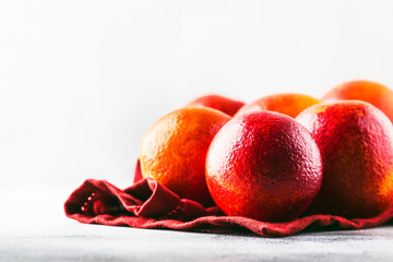 Red bloody oranges for making freshly squeezed juice, gray table background, selective focus, place...