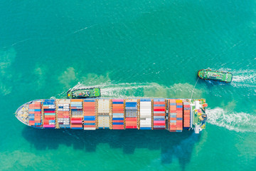 Aerial view and top view. Container ship in pier with crane bridge carries out export  and import...