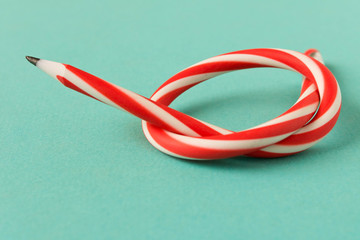 Flexible pencil . Isolated on blue background. Bending pencil.