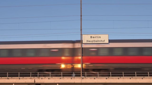berlin railway billboard train passing behind train station signboard