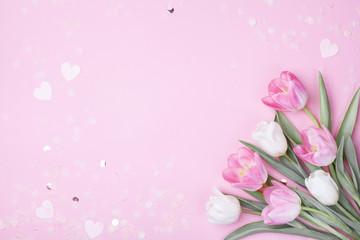 Spring tulip flowers on pastel pink background top view. Greeting card for International Women Day,...
