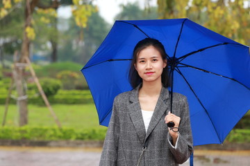 young woman standing in the rain