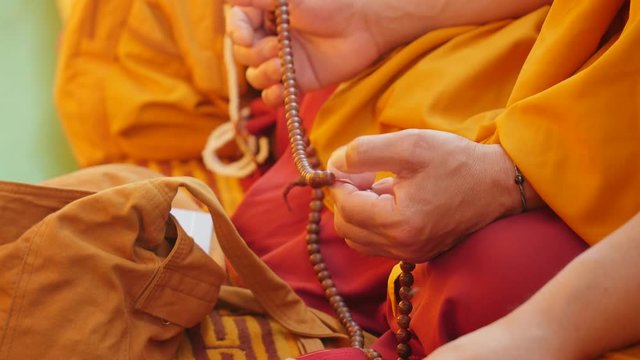 Tibetian monk counts beads