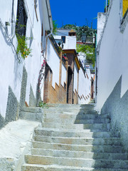 Albaicin, Old muslim quarter district narrow street in  Granada, Spain. White houses. 