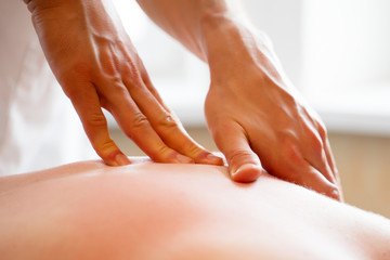 Picture of hands of man making massage to woman.