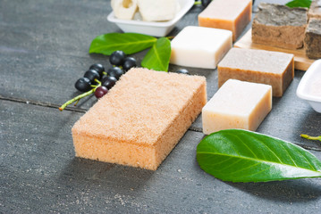 cosmetic clay, soaps, henna blocks, raw shea butter on black wood table