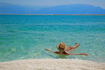 Girl relaxing in the water of Dead Sea