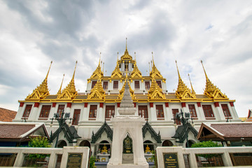 Fototapeta premium Loha Prasat , The metallic castle covered with gold leaf at of Wat Ratchanadda Temple in Bangkok, Thailand.