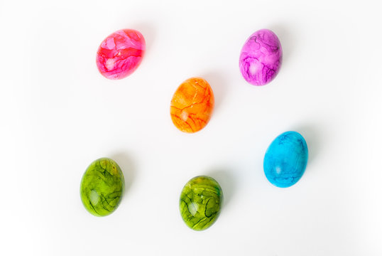 Colorful painted easter eggs laying on white background