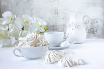 Meringues.  Protein sugar cake for tea or coffee. Light background.White morning. Candy