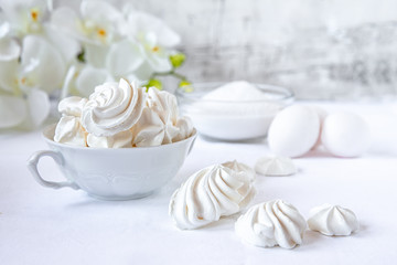 Meringues.  Protein sugar cake for tea or coffee. Light background.White morning. Candy