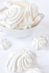 Meringues.  Protein sugar cake for tea or coffee. Light background.White on white.
